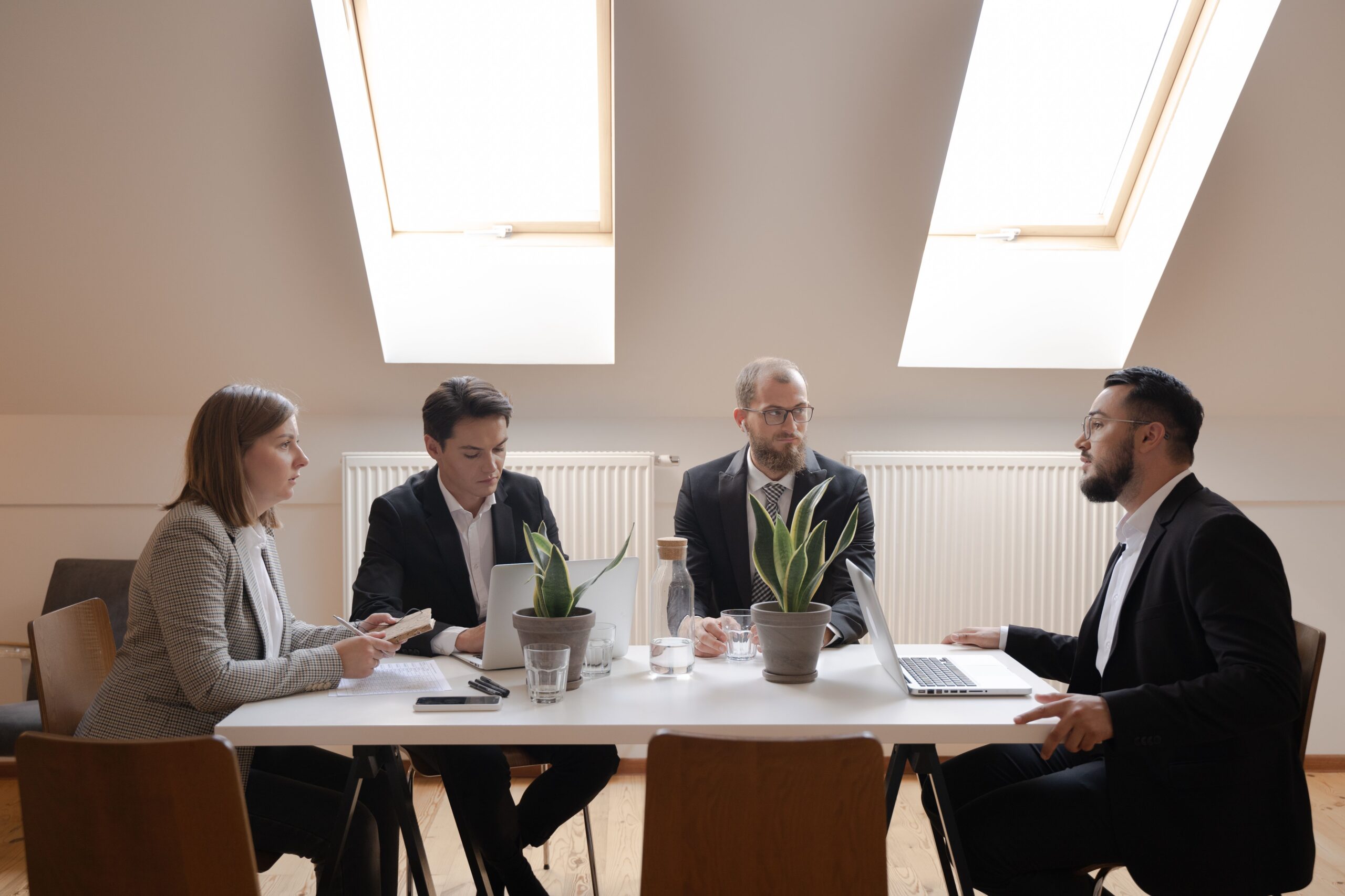 Executor Law - What Happens to Your Business When You Die? A group of business professionals in a serious discussion around a boardroom table