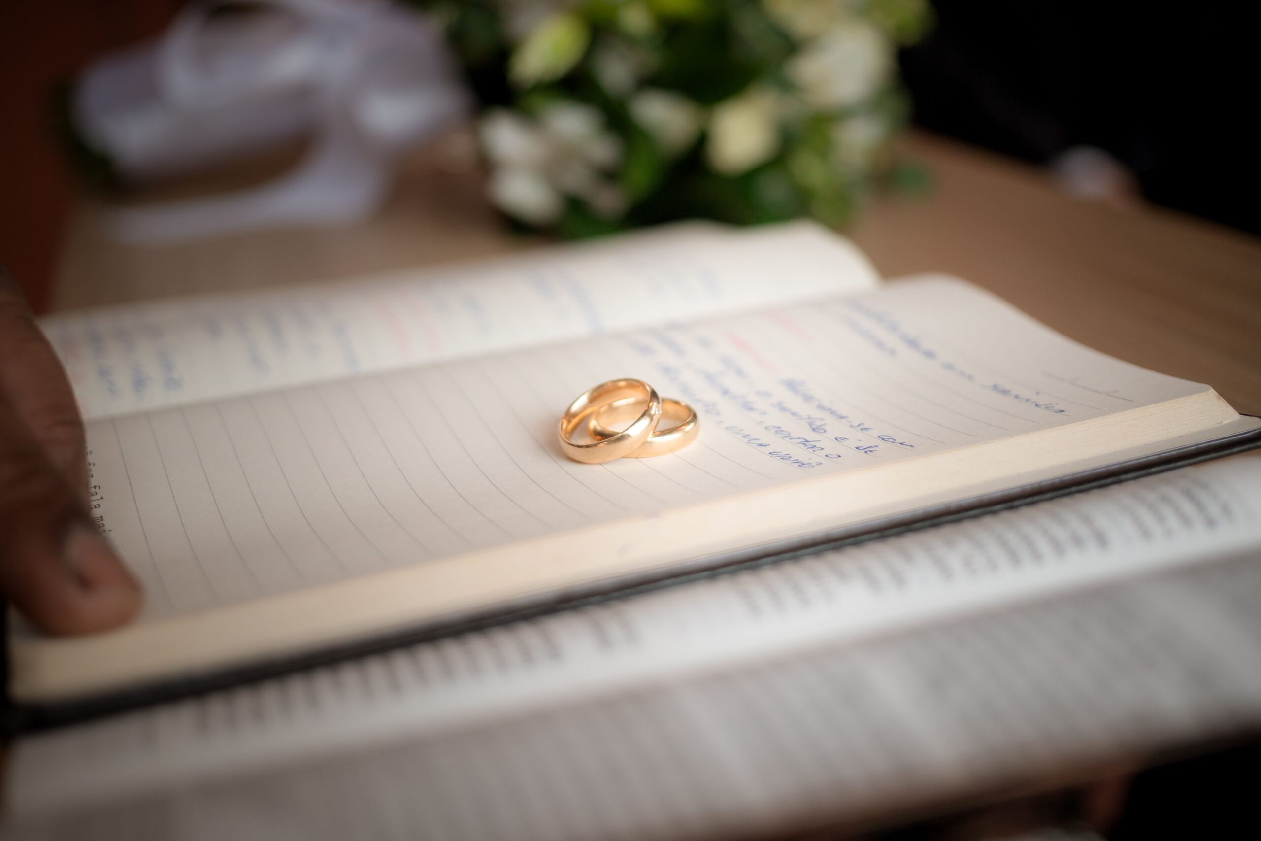 Wedding rings on a document, representing a primary residence passing to a surviving spouse