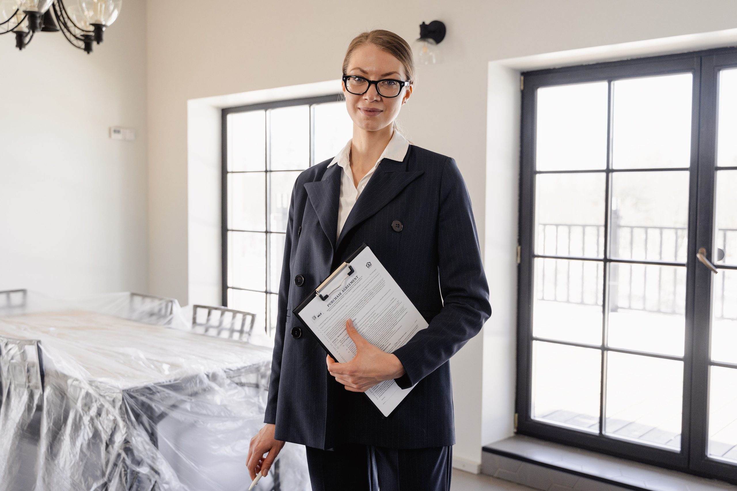 Conveyancer holding clipboard and purchase agreement.
