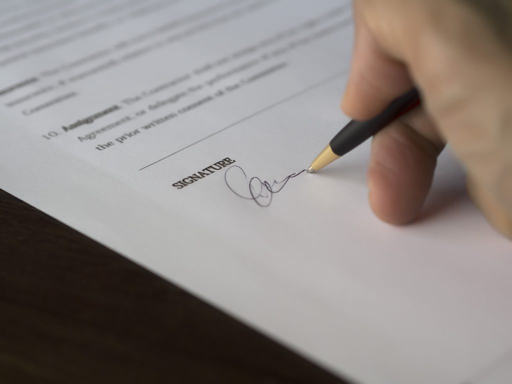 Hand signing legal document related to deceased estate debt