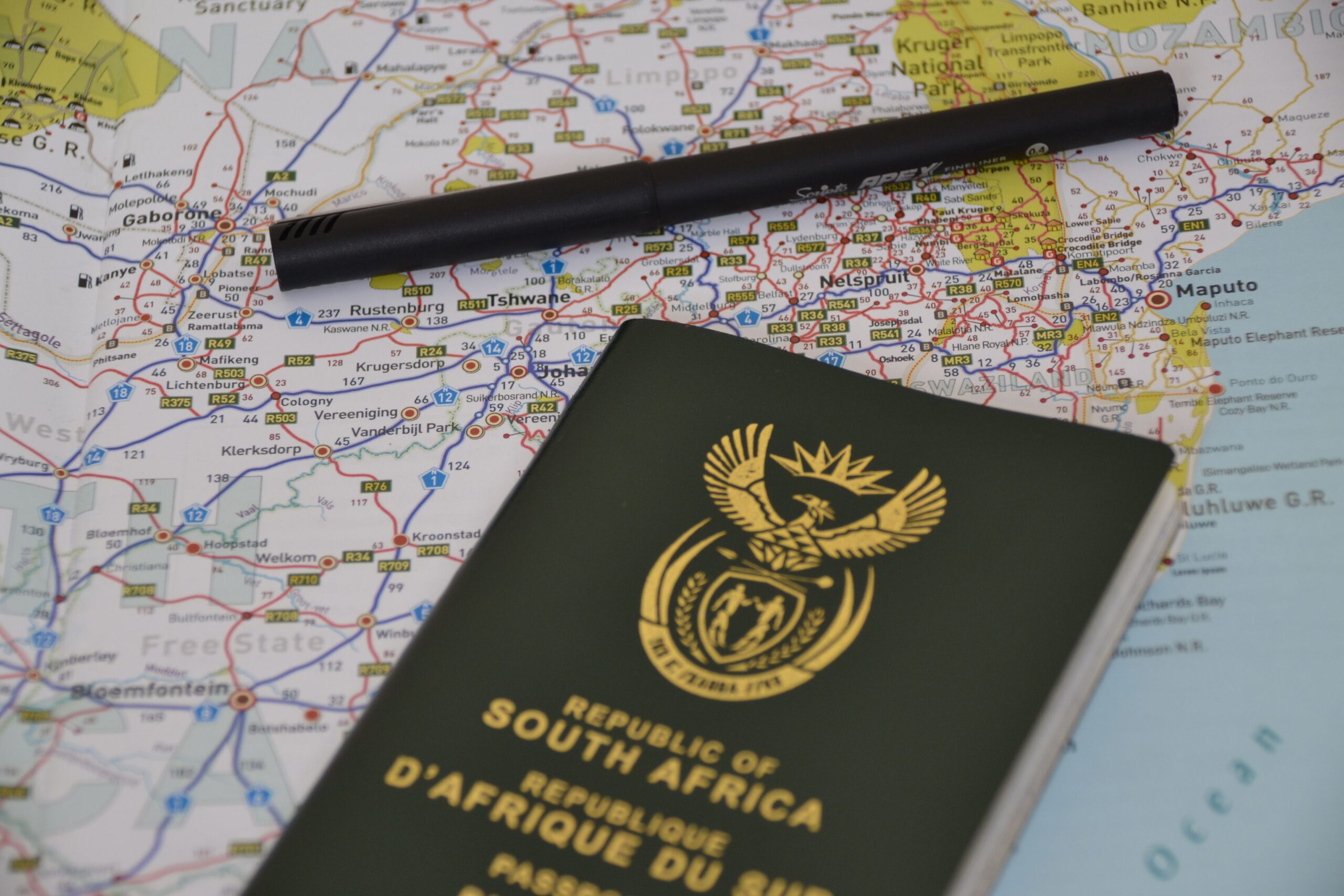 Executor Law - Cross-Border Estates: Administration Localised, Tax Worldwide Passport, pen, and world map symbolising cross-border estates planning